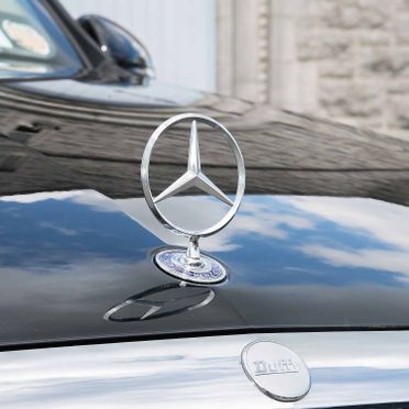 Close up of the Mercedes-Benz insignia on a hearse